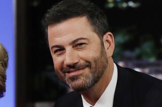 FILE - In this Aug. 22, 2016, file photo, ABC talk show host Jimmy Kimmel poses with then Democratic presidential nominee Hillary Clinton, unseen, during a break in taping of "Jimmy Kimmel Live!" in Los Angeles. Kimmel announced Wednesday, June 17, 2021, on his show that he will be the title sponsor of college football's LA Bowl that is scheduled to be played Dec. 18 at SoFi Stadium in Inglewood, Ca. (AP Photo/Carolyn Kaster, File)