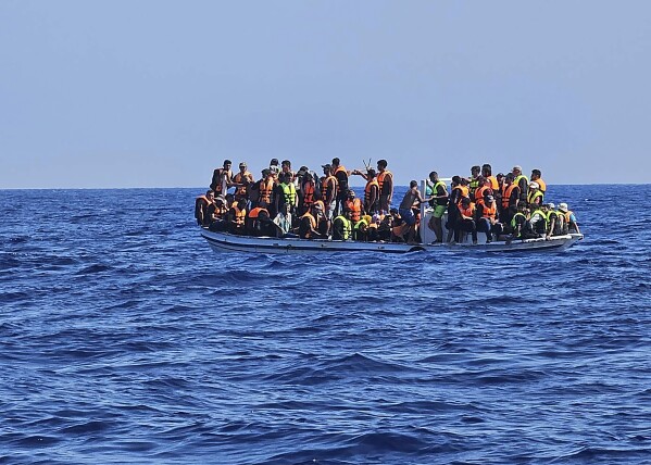 This image provided from Cyprus' Joint rescue Coordination Center shows a boat with migrants in the sea near the eastern coastal resort of Protaras, on the east side of the Mediterranean island of Cyprus, on Sunday, Aug. 21, 2023. Cyprus police have rescued 18 Syrian migrants after their boat started taking on water some 3.5 miles off the southeastern coast. Police said the 11 men, three unescorted minors, one woman and her three children had set sail from Tartus, Syria and were brought ashore aboard a police patrol vessel. (Joint Rescue Coordination Center via AP)