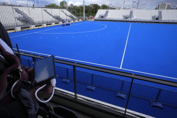 A cyber-security experts hold a tablet at the Yves du Manoir stadium, Friday, May 3, 2024 in Colombes, outside Paris. Cyber-security teams working to protect the Paris Games from hackers and other attackers aren't willing to divulge too much detail about their work. But they no doubt that cyber-criminals are going to keep them busy. (Ǻ Photo/Michel Euler)