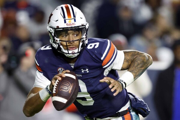 FILE - Auburn quarterback Robby Ashford rolls out to pass against Texas A&M during the first half of an NCAA college football game Saturday, Nov. 12, 2022, in Auburn, Ala. Auburn opens their season at home against UMass on Sept. 2. (AP Photo/Butch Dill, File)
