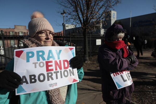 Anti-abortion protesters Jean Bullock, left, and Sue Dunn, demonstrate outside Planned Parenthood Great Rivers, Dec. 5, 2024, at in St. Louis, Mo. (Laurie Skrivan/St. Louis Post-Dispatch via AP, File)
