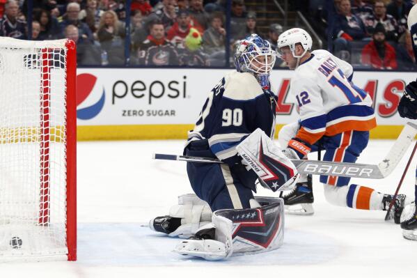 New York Islanders forward Josh Bailey, right, scores past Columbus Blue Jackets goalie Elvis Merzlikins during the first period of an NHL hockey game in Columbus, Ohio, Tuesday, March 29, 2022. (AP Photo/Paul Vernon)