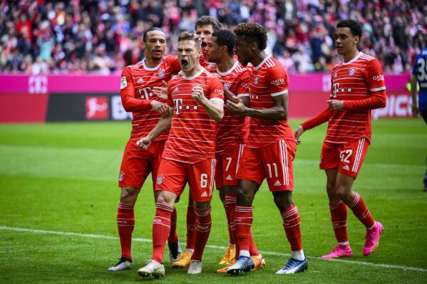 Munich's scorer Joshua Kimmich, front left, celebrates with his teammates after scoring his side's second goal during the German Bundesliga soccer match between FC Bayern Munich and FC Schalke 04 in Munich, Germany, Saturday, May 13, 2023. (Tom Weller/dpa via AP)