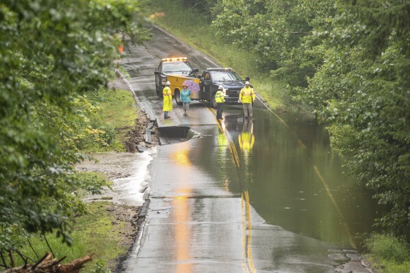 Jackson Hill Road in Auburn is washed out on Tuesday, Aug. 8, 2023, in Auburn, Maine, following heavy rain. (Andree Kehn/Sun Journal via AP)