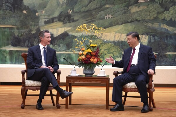 In this photo taken Wednesday, Oct 25, 2023, and released by Office of the Governor of California , California Gov. Gavin Newsom, left, meets with Chinese President Xi Jinping at the Great Hall of the People in Beijing. (Office of the Governor of California via AP)