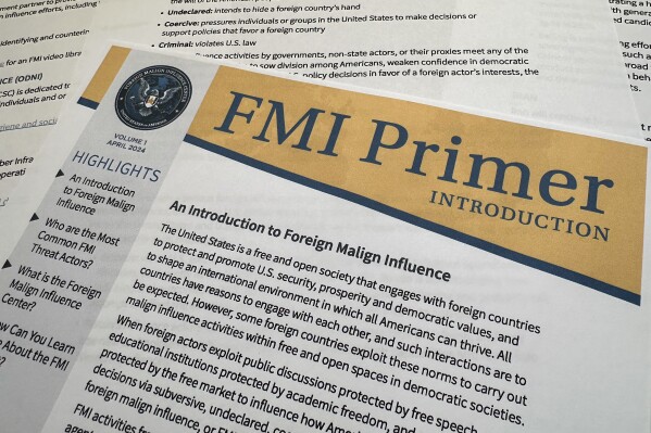 A document about the Foreign Malign Influence Center, a division of the Office of the Director of National Intelligence, is photographed Wednesday, June 12 2024. Federal officials who track disinformation campaigns say they are issuing more warnings to political candidates, government officials and others targeted by foreign groups as America's adversaries seek to influence the 2024 election. (AP Photo/Jon Elswick