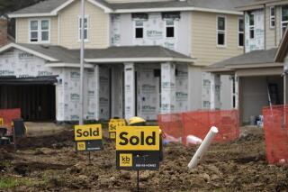 Sold signs stand in front of new homes under construction Monday, March 15, 2021, in Houston.  Sales of new homes fell a bigger-than-expected 5.9% in April, a drop that analysts blamed in part on soaring home prices.  (AP Photo/David J. Phillip)