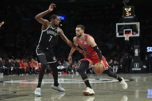 Chicago Bulls guard Zach LaVine (8) drives against Brooklyn Nets forward Kevin Durant (7) during the first half of an NBA basketball game Tuesday, Nov. 1, 2022, in New York. (AP Photo/Jessie Alcheh)