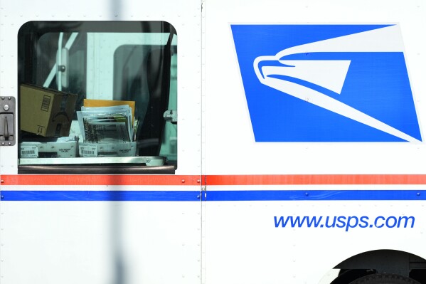FILE - Letters and packages are loaded on a U.S. Postal Service truck parked outside a post office in Wheeling, Ill., Monday, Jan. 29, 2024. As many Americans celebrate Memorial Day on Monday, May 27, 2024, there are several stores, government offices and businesses that will be open or closed. (AP Photo/Nam Y. Huh, File)