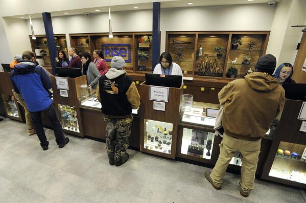 FILE — People stood in line for hours at Rise in Mundelein, Ill., Jan. 1, 2020, waiting to legally buy different forms of marijuana. New York's plan, proposing a $200 million fund to help people of color, women and some others start marijuana businesses, takes a page from Illinois, which is working with private lenders to make an initial round estimated at up to $34 million in loans. (Mark Welsh/Daily Herald via AP, File)