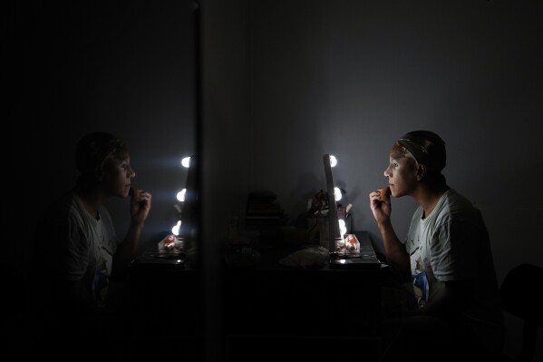 Mari Con Carne applies their makeup before attending Les Miserables at the Kennedy Center in drag, on the night that President Donald Trump and first lady Melania Trump were also in attendance, Wednesday, June 11, 2025, in Washington. (AP Photo/Julia Demaree Nikhinson)