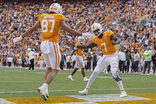 Tennessee quarterback Joe Milton III (7) celebrates a touchdown with tight end Jacob Warren (87) during the first half of an NCAA college football game against Vanderbilt Saturday, Nov. 25, 2023, in Knoxville, Tenn. (AP Photo/Wade Payne)
