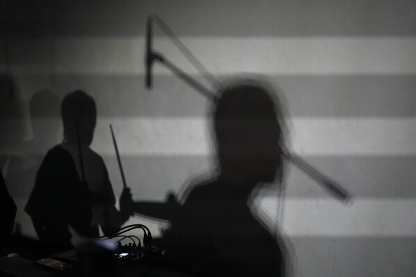 Members of Chinese punk band Demerit performs during a punk festival in Hangzhou, China, Friday, Jan. 17, 2025. (AP Photo/Aaron Favila)