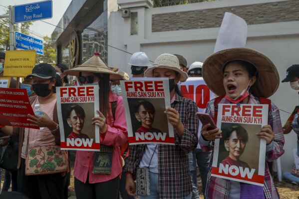 Anti-coup protesters display placards near Indonesian Embassy in Yangon, Myanmar Wednesday, Feb. 24, 2021. Anti-coup protesters gathered outside the Indonesian Embassy following reports that Indonesia was seeking to have fellow members of the Association of Southeast Asian Nations to agree on an action over the Myanmar's coup that would hold the junta to its promise to hold free and fair elections in a year's time. The Indonesia Foreign Ministry has denied the report. (AP Photo)