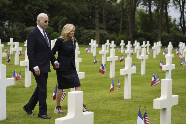 President Joe Biden and first lady Jill Biden walk in the Normandy American Cemetery following a ceremony to mark the 80th anniversary of D-Day, Thursday, June 6, 2024, in Normandy. (AP Photo/Evan Vucci)