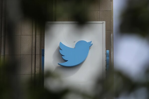 FILE - This July 9, 2019, file photo shows a sign outside of the Twitter office building in San Francisco. Social media companies have vowed to tackle misinformation in politics. Social media companies have vowed to tackle misinformation in politics. But when Britain's Conservative Party changed its press office Twitter account Tuesday, Nov. 19, to look like a fact-checking site during a televised debate, the only consequence was a promise from Twitter to take action if they did it again. (AP Photo/Jeff Chiu, File)
