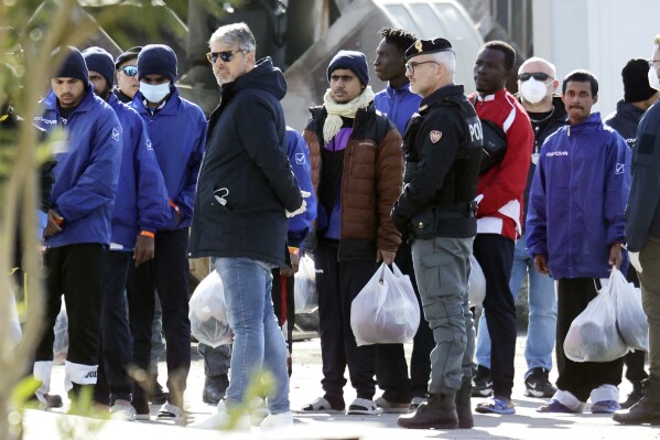 Migrants follow the authorities after their arrival in the port of Shengjin, northwestern Albania, Tuesday, Jan. 28, 2025. (AP Photo/Vlasov Sulaj, File)