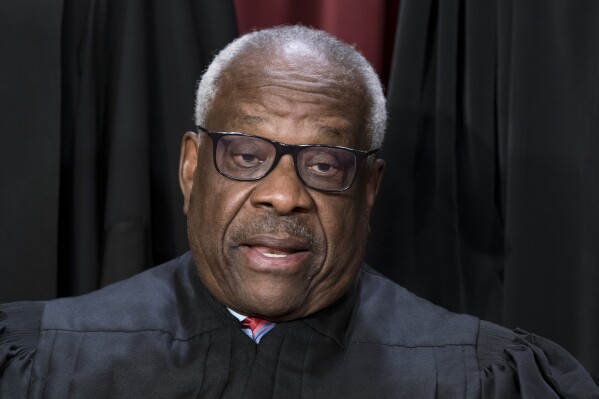 FILE - Associate Justice Clarence Thomas joins other members of the Supreme Court as they pose for a new group portrait, at the Supreme Court building in Washington, Oct. 7, 2022. (AP Photo/J. Scott Applewhite, File)