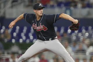 Atlanta Braves starting pitcher Kyle Wright (30) aims a pitch during the third inning of a baseball game against the Miami Marlins, Wednesday, May 3, 2023, in Miami. (AP Photo/Marta Lavandier)