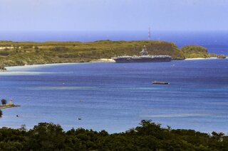The USS Theodore Roosevelt, a Nimitz-class nuclear powered aircraft carrier, is docked along Kilo Wharf of Naval Base Guam in Sumay,  Friday, April 3, 2020. The aircraft carrier, with a crew of nearly 5,000, is docked in Guam, and the Navy has said as many as 3,000 will be taken off the ship and quarantined by Friday. More than 100 sailors on the ship have tested positive for the virus, but none is hospitalized.  (Rick Cruz/The Pacific Daily via AP)