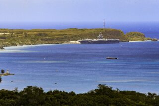 The USS Theodore Roosevelt, a Nimitz-class nuclear powered aircraft carrier, is docked along Kilo Wharf of Naval Base Guam in Sumay, Friday, April 3, 2020. The aircraft carrier, with a crew of nearly 5,000, is docked in Guam, and the Navy has said as many as 3,000 will be taken off the ship and quarantined by Friday. More than 100 sailors on the ship have tested positive for the virus, but none is hospitalized. (Rick Cruz/The Pacific Daily via AP)