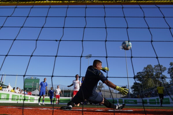 Ukraine's goalkeeper deflects a shot by a Poland player at the Homeless World Cup, Tuesday, July 11, 2023, in Sacramento, Calif. (AP Photo/Godofredo A. Vásquez)