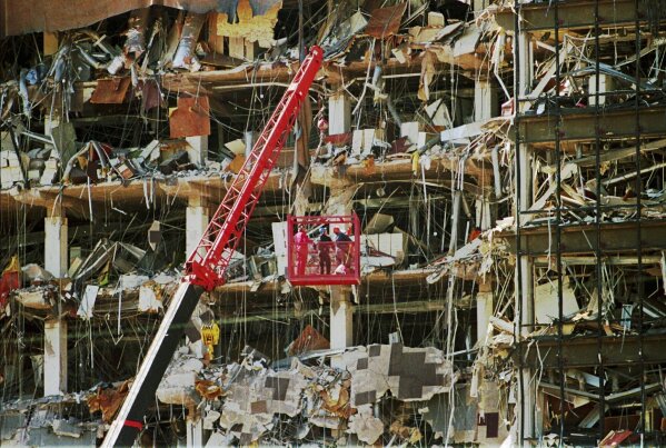 Rescue workers dig through the rubble from the Alfred P. Murrah Federal Building explosion in downtown Oklahoma City on April 20, 1995. (AP Photo/J.Pat Carter, File)