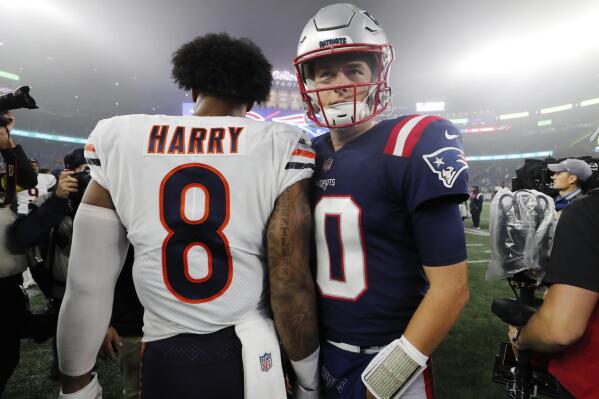 New England Patriots quarterback Mac Jones (10) passes Chicago Bears wide receiver N'Keal Harry (8) following an NFL football game, Monday, Oct. 24, 2022, in Foxborough, Mass. (AP Photo/Michael Dwyer)