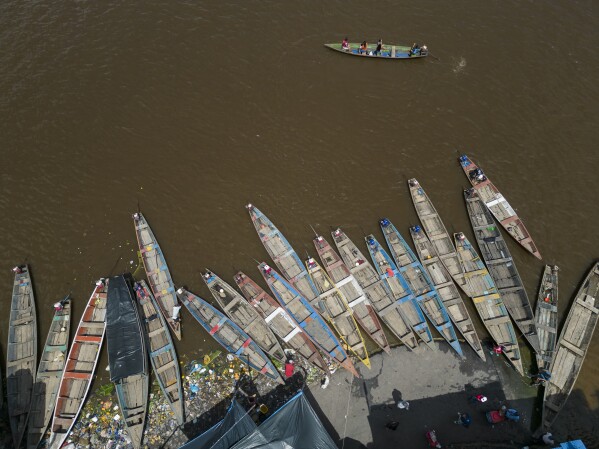 A boat transport commuters on the Itaya river in the Belen neighborhood of Iquitos, Peru, Saturday, May 25, 2024. (AP Photo/Rodrigo Abd)