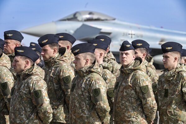 In this photo provided by Lithuanian Ministry of National Defense, Lithuania's army soldiers attend the celebration for Lithuania's NATO membership 20th anniversary at the Siauliai airbase, some 230 km (144 miles) east of the capital Vilnius, Lithuania, Thursday, March 28, 2024. (Alfredas Pliadis/Lithuanian Ministry of National Defense via AP)