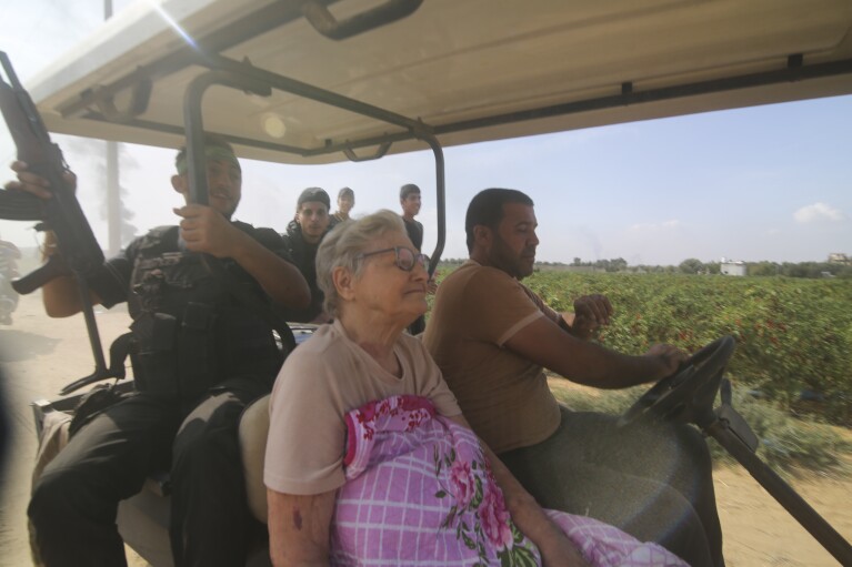 Palestinians and Hamas militants transport Yaffa Adar, 85, to Gaza after kidnapping her from her home in Nir Oz, a kibbutz in Israel near the Gaza border, on Oct. 7, 2023. Hamas militants stormed the border with Israel, killed over 1,200 Israelis, and took over 200 hostages. (AP Photo)