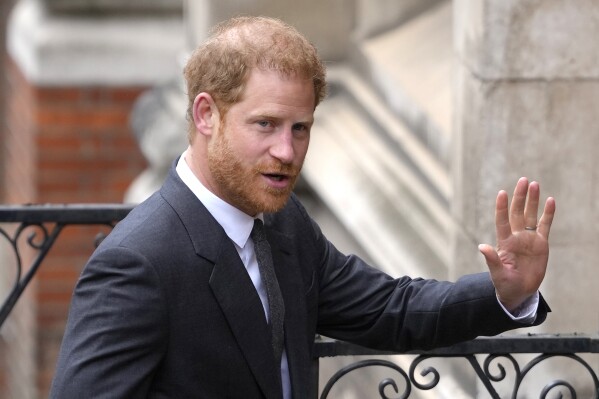 FILE - Britain's Prince Harry salutes media as he arrives at the Royal Courts of Justice in London, on March 30, 2023. Prince Harry is attending a charity event in London, though he isn’t expected to meet with King Charles III or Prince William as Britain prepares to mark the first anniversary of Queen Elizabeth II’s death. Harry’s relationship with his family has been strained since he and his wife, Meghan, moved to California in 2020. (AP Photo/Kirsty Wigglesworth, File)