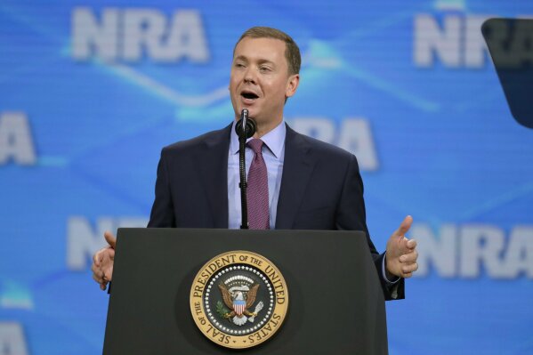 FILE- In this April 26, 2019 file photo, National Rifle Association Institute for Legislative Action Executive Director Christopher W. Cox speaks at the NRA-ILA Leadership Forum in Lucas Oil Stadium in Indianapolis. The National Rifle Association's top lobbyist has resigned in another sign of infighting within the powerful gun lobbying group, Wednesday, June 26, 2019. Cox's departure comes just days after the NRA placed him on administrative leave, claiming he was part of a failed attempt to extort the longtime CEO. (AP Photo/Michael Conroy, File)
