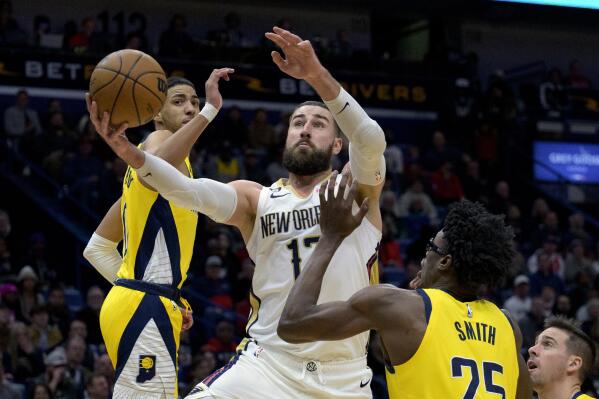 New Orleans Pelicans center Jonas Valanciunas (17) shoots against Indiana Pacers guard Tyrese Haliburton, left, and Indiana Pacers forward Jalen Smith (25) in the first half of an NBA basketball game in New Orleans, Monday, Dec. 26, 2022. (AP Photo/Matthew Hinton)