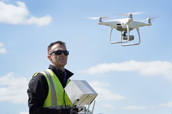 FILE - Michael Jones operates his drone, April 2, 2021, in Goldsboro, N.C. A North Carolina board that regulates land surveyors didn't violate the drone photography pilot's constitutional rights when it told him to stop advertising and offering aerial map services because he lacked a state license, a federal appeals court ruled on Monday, May 20, 2024. (AP Photo/Gerry Broome, File)