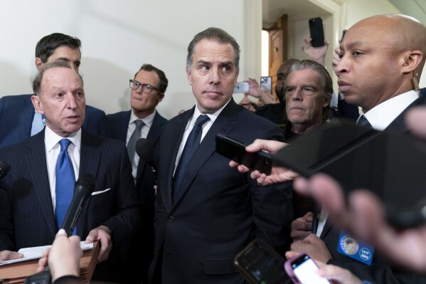 Hunter Biden, President Joe Biden's son, accompanied by his attorney Abbe Lowell, talks to reporters as they leave a House Oversight Committee hearing as Republicans are taking the first step toward holding him in contempt of Congress, Wednesday, Jan. 10, 2024, on Capitol Hill in Washington. (AP Photo/Jose Luis Magana)