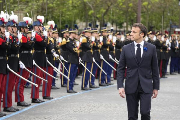 French President Emmanuel Macron reviews the troops during ceremonies marking Victory Day, Monday, May 8, 2023 in Paris. French President Emmanuel Macron presides over ceremonies in Paris and Lyon celebrating victory over the Nazis and commemorating victims of the Holocaust and French resistance fighters in World War II. (AP Photo/Michel Euler, Pool)