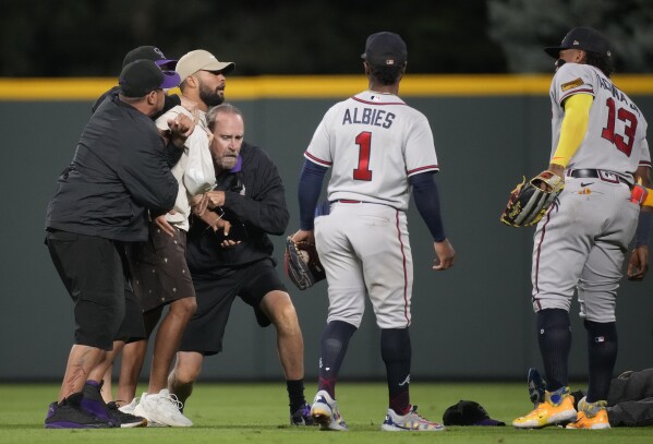 Fans run onto field and one makes contact with Atlanta Braves star Ronald  Acuña Jr.