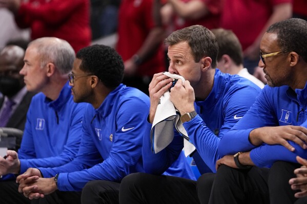 Duke head coach Jon Scheyer sits on the bench during the second half of an Elite Eight college basketball game against North Carolina State in the NCAA Tournament in Dallas, Sunday, March 31, 2024. (AP Photo/Tony Gutierrez)