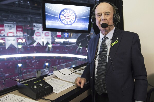 FILE - Broadcaster Bob Cole poses prior to calling his last NHL hockey game between the Montreal Canadiens and the Toronto Maple Leafs in Montreal, Saturday, April 6, 2019. Cole, the voice of hockey in Canada for a half-century, has died. He was 90. (Graham Hughes/The Canadian Press via AP, FIle)