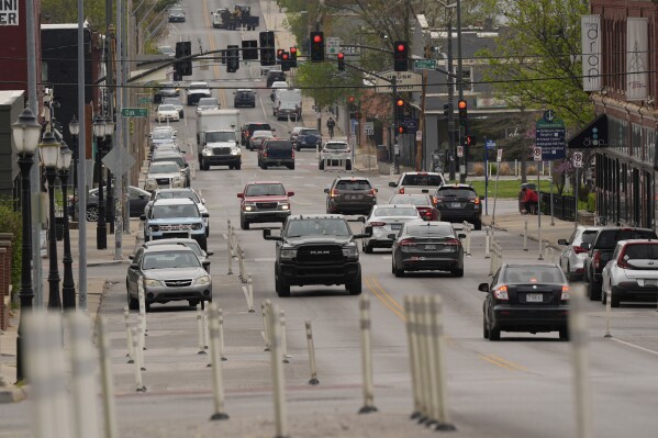 Motorists navigate 31st Street in Kansas City, Mo., where the city implemented a "road diet" reducing the street from four lanes to two in an effort to reduce speeding and accidents, Thursday, April 17, 2025. (AP Photo/Charlie Riedel)