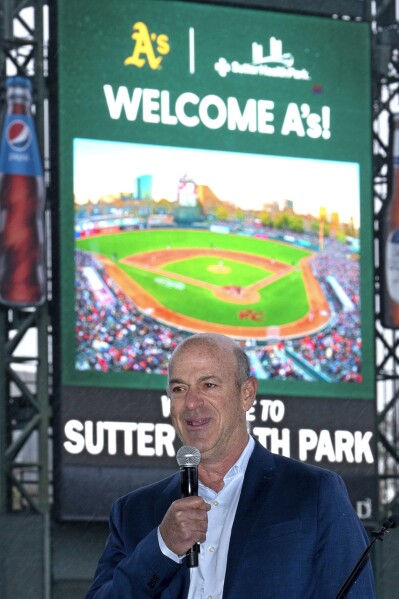 John Fisher, owner of the Oakland Athletics baseball team, announces that his team will leave Oakland after this season and play temporarily at a minor league park, during a news conference in West Sacramento, Calif., Thursday, April 4, 2024. The A's announced the decision to play at the home of the Sacramento River Cats from 2025-27 with an option for 2028 on Thursday after being unable to reach an agreement to extend their lease in Oakland during that time. (AP Photo/Rich Pedroncelli)