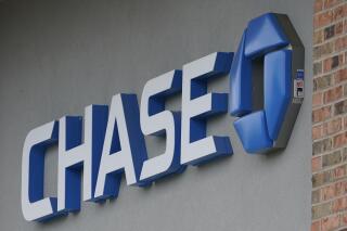 A Chase bank sign in Richmond, Va., Wednesday, June 2, 2021. PMorgan reports earnings on Friday, April 14, 2023. (AP Photo/Steve Helber, File)