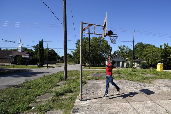Brent Williams plays basketball in Houston's Third Ward on Sunday, June 7, 2020, where George Floyd grew up. (AP Photo/David J. Phillip, File)