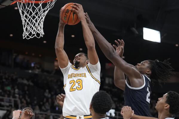 Providence forward Bryce Hopkins (23) grabs a rebound as Georgetown forward Bradley Ezewiro (22) vies for the ball in the second half of an NCAA college basketball game, Wednesday, Feb. 8, 2023, in Providence, R.I. (AP Photo/Steven Senne)