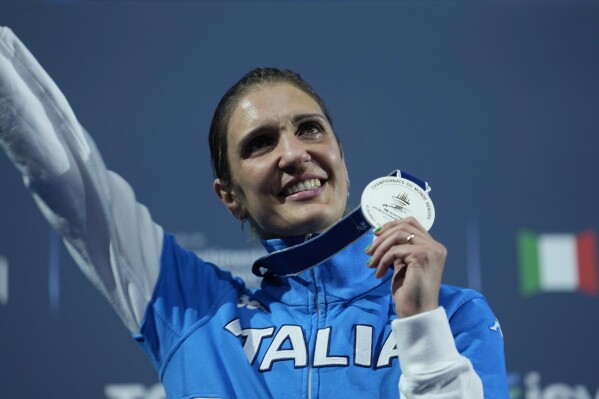 FILE - Italy's Arianna Errigo celebrates on the podium her silver medal after the women's Individual Foil final against Italy's Alice Volpi, at the Fencing World Championships in Milan, Italy, on July 26, 2023. Fencer Arianna Errigo and high jumper Gianmarco Tamberi were named as Italy’s flagbearers Monday, April 29, 2024 for the Paris Olympics opening ceremony. (AP Photo/Luca Bruno)