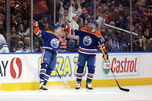 Edmonton Oilers' Connor McDavid (97) and Mattias Ekholm (14) celebrate a goal against the Toronto Maple Leafs during first period NHL action in Edmonton on Wednesday March 1, 2023.THE CANADIAN PRESS/Jason Franson/The Canadian Press via AP)