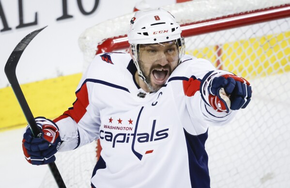 Washington Capitals forward Alex Ovechkin (8) celebrates his goal during the second period of an NHL hockey game against the Calgary Flames in Calgary, Alberta, Monday, March 18, 2024. (Jeff McIntosh/The Canadian Press via AP)