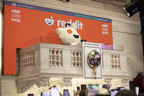 Reddit mascot Snoo rings the New York Stock Exchange opening bell, prior to the company's IPO, Thursday, March. 21, 2024. (AP Photo/Yuki Iwamura)