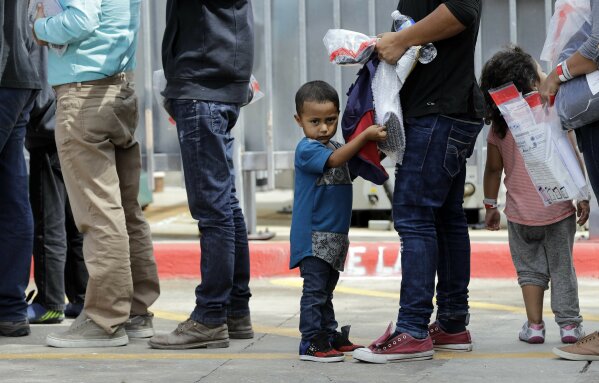 
              Immigrants line up to enter the central bus station after they were processed and released by U.S. Customs and Border Protection, Sunday, June 24, 2018, in McAllen, Texas. (AP Photo/David J. Phillip)
            